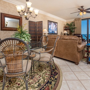 Enjoy meals at the glass dining table with views of the beach just beyond the large windows
