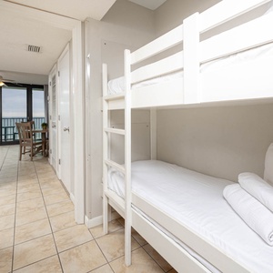 Discover the cozy bunk area, perfect for kids, with fresh linens and easy access to the living area