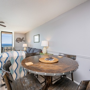 Gather around the rustic dining table, enjoying meals surrounded by inviting decor and beachfront views