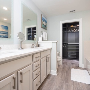 Pamper yourself in this master bath with dual-sink vanity, a soothing jetted tub, glass walk-in shower, and fluffy towels