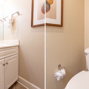 Additional half bath featuring a spacious vanity, elegant decor, and plush towels for your comfort