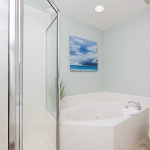 Indulge in relaxation in the master bath with a refreshing walk-in shower and soothing jetted tub