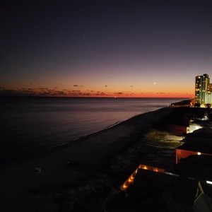 Experience peaceful evenings from your balcony, soaking in vibrant coastal views as twilight paints the sky