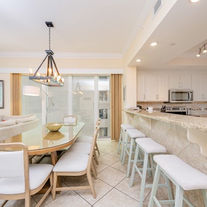 Gather around the elegant dining table for heartfelt conversations while enjoying warm coastal breezes