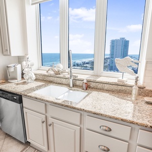 This kitchen features a stunning beach view from large windows