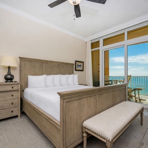 Retreat to the king master suite with cozy bedding and drift off to the sound of the waves from the balcony