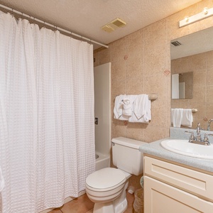 Master bathroom featuring a shower/tub combo, modern fixtures, and plush towels for a relaxing stay
