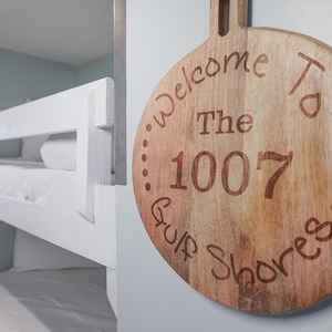 This cozy space features a charming bunk bed, perfect for kids, along with a warm welcome sign for guests