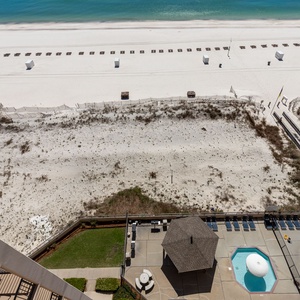 Relax by the poolside cabana, enjoying the sun and easy access to the beach just steps away