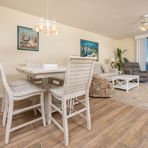 Relax in the inviting living space with comfortable seating and a dining area, perfect for meals with a view