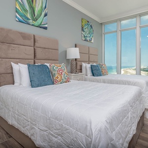 Wake to the breathtaking coastline in this queen guest suite with two cozy beds and colorful decor