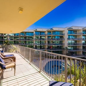 Bask in the warm sun on the spacious balcony while enjoying soothing views of the pool and lush surroundings