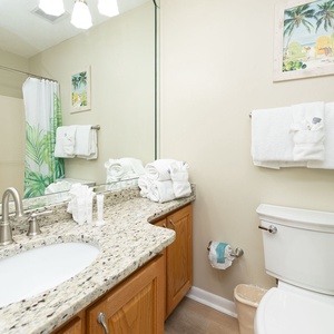 Fresh towels and gentle bath products await you in the guest suite bathroom with coastal accents