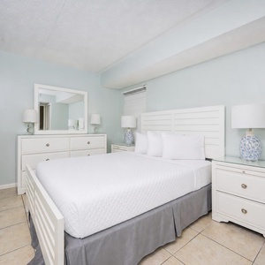 This bedroom features a comfortable bed, stylish decor, and ample storage for a relaxing stay