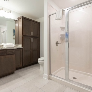 Enjoy a refreshing shower in this guest bath with a spacious vanity and sleek cabinetry