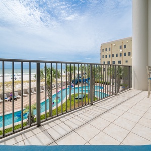 Experience the view from the balcony overlooking the lazy river and pristine beach, perfect for unwinding in the sun