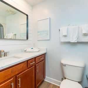 Refresh in your guest bath, where elegant details and soft towels enhance your tranquil routine by the coast