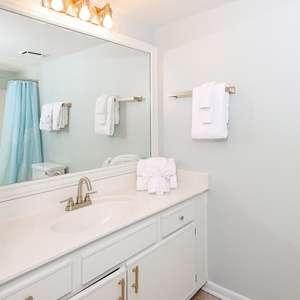 Refresh in the guest bathroom featuring a spacious vanity, stylish fixtures, and fluffy towels for your comfort