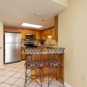 Gather around the granite breakfast bar with seating, perfect for casual meals and morning coffee in the kitchen