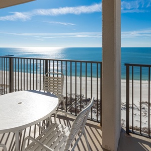 Savor meals at the balcony table while enjoying expansive views of the tranquil waters and shoreline below