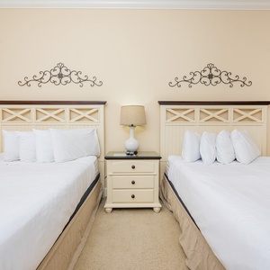Relaxing guest bedroom featuring a queen and a full bed, soft linens, and elegant decor for a relaxing stay