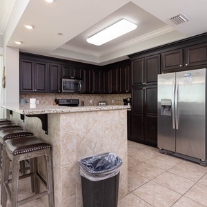 Gather around the breakfast bar with stylish seating and enjoy the inviting atmosphere of this stylish kitchen