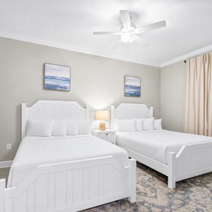 Inviting guest room featuring two queen beds and soft decor for restful nights