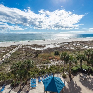 Enjoy the inviting outdoor space with lounge chairs and a gazebo, perfect for relaxing while taking in the coastal views