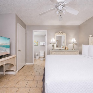 Rest in the guest suite where lamps cast gentle illumination and the TV invites streaming your favorite show