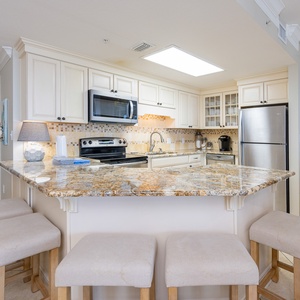 Granite breakfast bar surrounds the kitchen where you prepare fresh meals for family gatherings