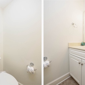 Additional half bath featuring a spacious vanity, soft towels, and cheerful beach-themed artwork