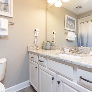 Freshen up in this guest bath in the relaxing shower or soothing tub before an exciting beach day