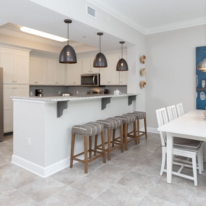 Sip your morning coffee at the breakfast bar and get ready for a beach day in this stylish space