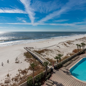 Enjoy stunning beachfront views and a relaxing atmosphere from this inviting balcony overlooking sparkling pools