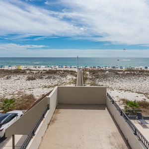 This inviting view showcases a beachside pathway leading to the sandy shore, perfect for relaxing days by the water