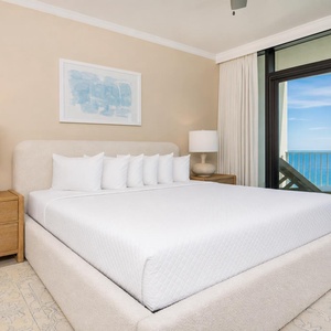 Unwind in the master bedroom, featuring a king bed and stunning views of the beach
