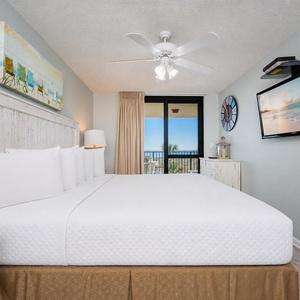 Dream peacefully on the king bed in the master suite while a coastal breeze drifts from your balcony door