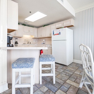 Bright coastal kitchen featuring light cabinetry, stylish countertops, and a spacious dining area for relaxed meals