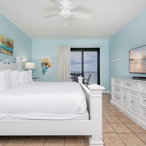Brightly colored artwork complements the master bedroom featuring a king bed and a balcony with a gulf view