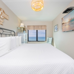 Rest on the plush king bed while watching your favorite shows, with stunning coastal views just outside your window