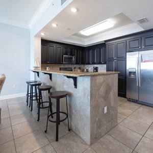 Gather at the sleek granite bar or dining table, enjoying the inviting atmosphere and stylish decor