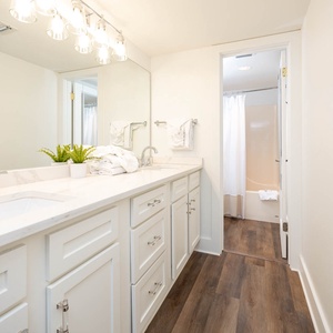 Refresh in this stylish master bath featuring a spacious vanity, ample storage, and a relaxing tub-shower area