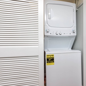 This laundry area features a stacked washer and dryer, providing convenience for your vacation needs