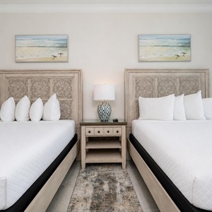 Indulge in relaxation in this guest room with dual queens and coastal decor