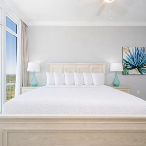 Relax on the cozy king bed in this guest suite and enjoy stunning coastal views