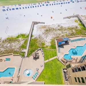 Balcony view of the beach, pools, and lounging areas from this elevated perspective, perfect for relaxation