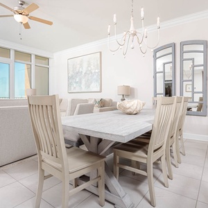 Gather around the charming dining table, creating lasting memories while savoring the warm coastal atmosphere