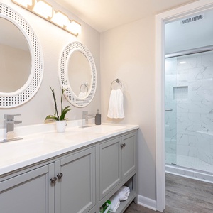 Brighten your morning routine in the master bath with a dual-sink vanity with stylish mirrors and a spacious walk-in shower