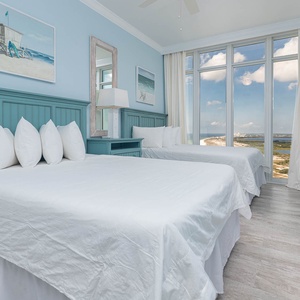 Wake to a breathtaking view in this queen guest suite with two cozy beds and expansive views from the windows