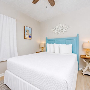 Tranquil guest bedroom featuring a queen bed, soft linens, and coastal decor that enhances your comfort
